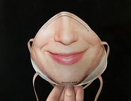 Photograph of an N95 mask with flair, made by the artist Danielle Baskin. Image portrays a white's woman face printed in a N95 mask.